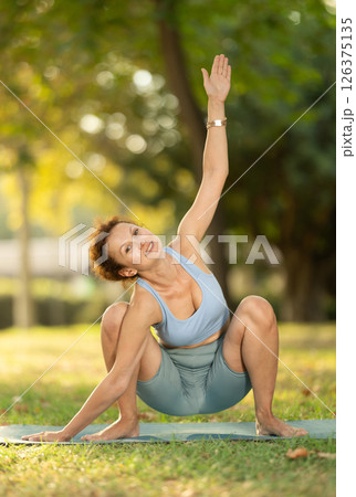 Adult woman doing yoga in garland pose 126375135