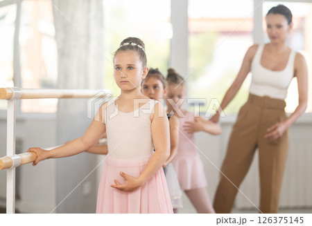Ballet choreographer teaches little children to get into first position Ballet choreographer teaches little children to get into first position 126375145