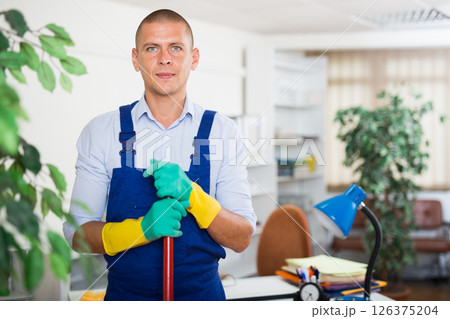 Professional cleaner in uniform ready for cleaning in office Professional cleaner in uniform ready for cleaning in office 126375204