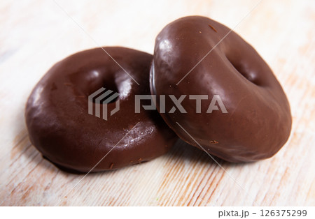 Two chocolate glazed donuts 126375299