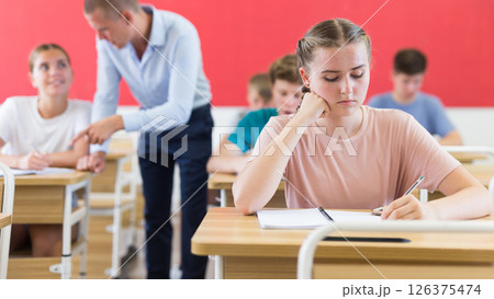 Young students sitting at desks in classroom Young students sitting at desks in classroom 126375474