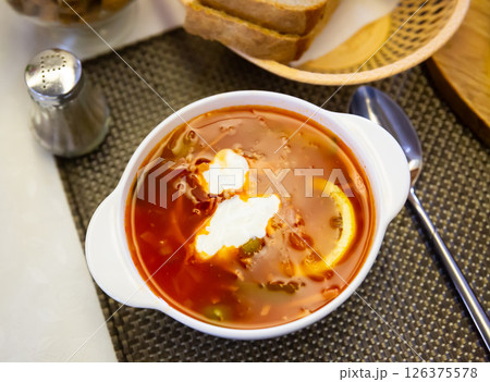 Traditional Russian meat soup Solyanka with sour cream and lemon Traditional Russian meat soup Solyanka with sour cream and lemon 126375578