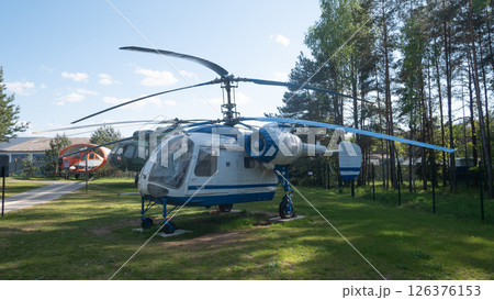 Vintage helicopters from the USSR era are displayed outdoors in a peaceful Russian landscape, showcasing their unique design and engineering. 126376153