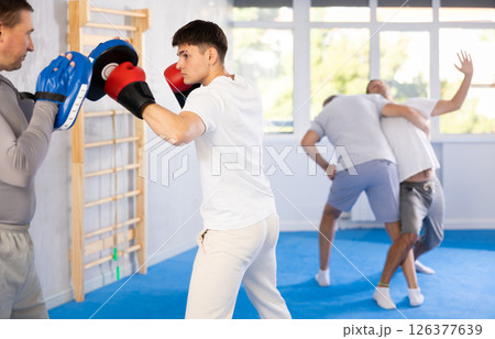 Two men training boxing fight in studio Two men training boxing fight in studio 126377639