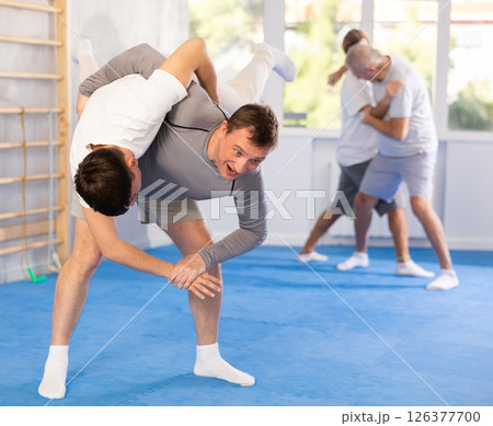 Two men training judo technique in studio 126377700