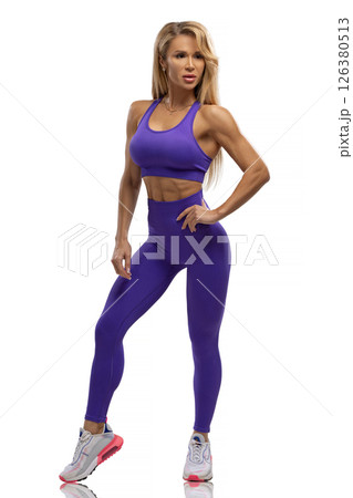Portrait of a blonde fitness girl posing in fashionable sportswear on a white cyclorama in the studio. Sports lifestyle. Portrait of a blonde fitness girl posing in fashionable sportswear on a white cyclorama in the studio. Sports lifestyle. 126380513