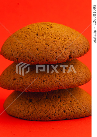 Delicious ginger cookies stacked against a vibrant background 126381098