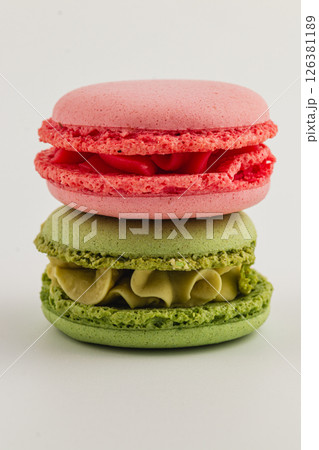 Colorful macaron desserts stacked on a white surface 126381189