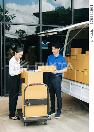 Express Delivery Service. Asian Courier Delivering Package to man Delivery service near van outside the warehouse, delivery home Express Delivery Service. Asian Courier Delivering Package to man Delivery service near van outside the warehouse, delivery home 126381661