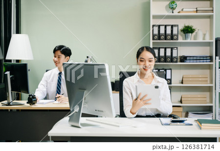 Business woman using tablet and laptop for doing math finance on an office desk, tax 126381714