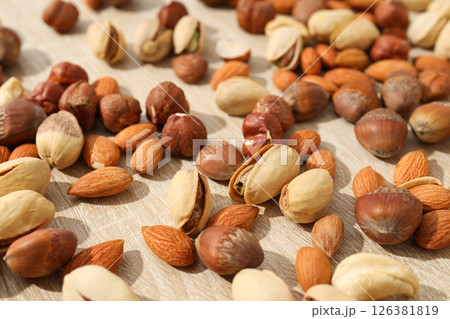 Assortment of different nuts on a wooden table 126381819