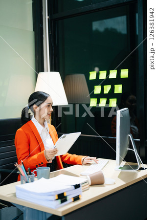 Business woman using tablet and laptop for doing math finance on an office desk, tax Business woman using tablet and laptop for doing math finance on an office desk, tax 126381942