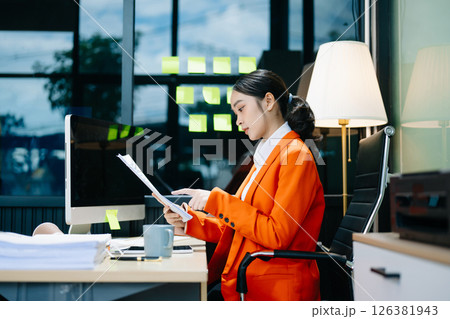 Business woman using tablet and laptop for doing math finance on an office desk, tax Business woman using tablet and laptop for doing math finance on an office desk, tax 126381943