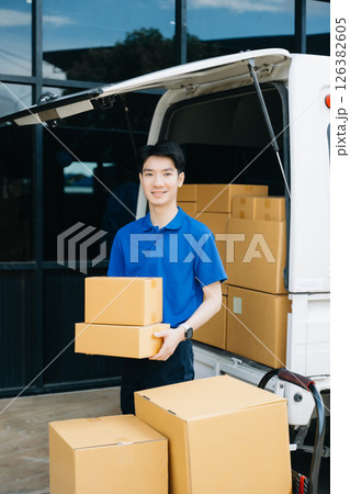 Asian courier delivery man searching the address on digital tablet. near van outside the warehouse. This is a freight transportation Asian courier delivery man searching the address on digital tablet. near van outside the warehouse. This is a freight transportation 126382605
