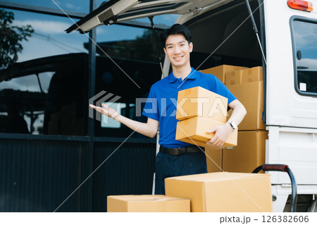 Asian courier delivery man searching the address on digital tablet. near van outside the warehouse. This is a freight transportation Asian courier delivery man searching the address on digital tablet. near van outside the warehouse. This is a freight transportation 126382606