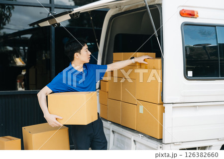 Asian courier delivery man searching the address on digital tablet. near van outside the warehouse. This is a freight transportation Asian courier delivery man searching the address on digital tablet. near van outside the warehouse. This is a freight transportation 126382660