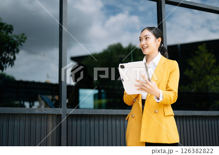 Young Asian business woman leader entrepreneur, professional manager holding digital tablet computer on the street 126382822