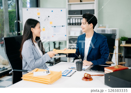 Asian business team and lawyers discussing contract papers sitting at the table. Concepts of law, 126383335