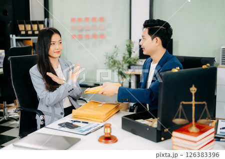 Lawyer refusing bribe money in the envelop from business man at the lawyer office. Lawyer refusing bribe money in the envelop from business man at the lawyer office. 126383396