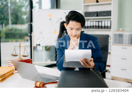 Attractive young lawyer in office Business man and lawyers discussing contract papers laptop Attractive young lawyer in office Business man and lawyers discussing contract papers laptop 126383404
