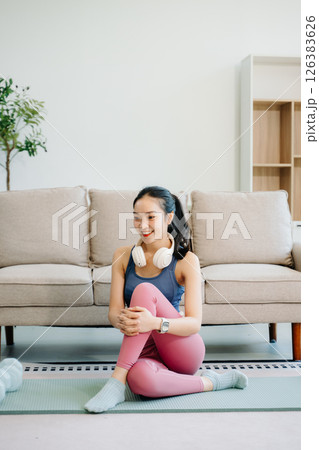 Asian Woman Doing Yoga and Watching Online Tutorials on tablet, Training 126383626
