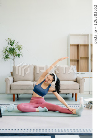 Asian Woman Doing Yoga and Watching Online Tutorials on tablet, Training Asian Woman Doing Yoga and Watching Online Tutorials on tablet, Training 126383652