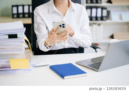 Confident businessman working on laptop, tablet and smartphone at her workplace 126383659