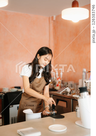 Explore professional Asian baristas brewing coffee, using notepads, digital tablets, and showcasing coffee Explore professional Asian baristas brewing coffee, using notepads, digital tablets, and showcasing coffee 126383746