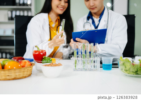 Nutritionists consulting on healthy food choices, meal planning, and wellness concepts Nutritionists consulting on healthy food choices, meal planning, and wellness concepts 126383928