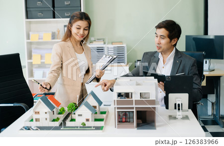 Modern office meeting of architects, designers, and developers creating innovative, sustainable housing projects 126383966