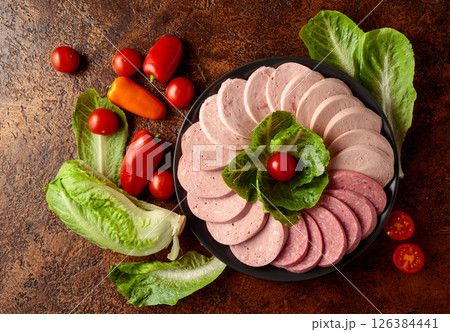 Various boiled sausages with greens and vegetables. Various boiled sausages with greens and vegetables. 126384441