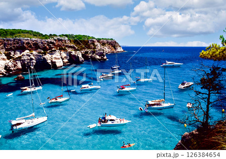 Clear water of Cala de Macarella in the Balearic Islands from Menorca. View of Cala de Macarella in Menorca with clear waters. Clear water of Cala de Macarella in the Balearic Islands from Menorca. View of Cala de Macarella in Menorca with clear waters. 126384654