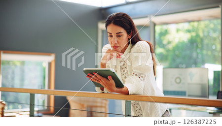 Tablet, thinking and businesswoman in office with research for planning wedding with online vendors. Digital technology, email and female event coordinator with feedback from client in workplace. 126387225