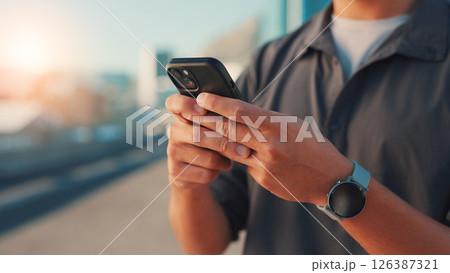 Man, hands or fitness with phone in city for workout app, tracking performance or chat. Closeup, male person or user browsing with mobile smartphone for exercise routine or schedule on space in town 126387321