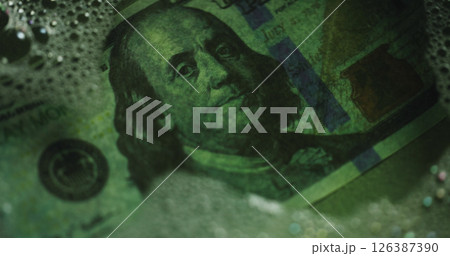 Money laundering, water and soap for crime, fraud or closeup for secret transaction in illegal business. Cash, dollar bills and corruption with bank notes in liquid, foam or financial scam for profit 126387390