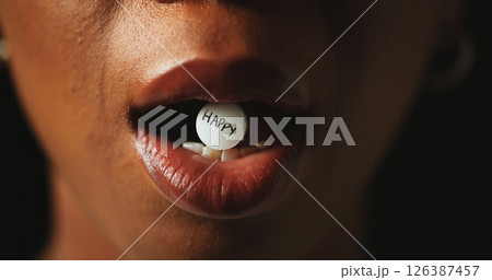 Mouth, tablet and addiction in studio closeup with text for mind altering drugs by black background. Person, pills and illegal medicine with opioid crisis, mood and happy word with chemical compound 126387457