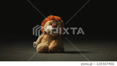 Dark, shadow and teddy bear in studio for loss, isolation and forgotten toy on ground. Night, floor and stuffed animal on black mockup space for neglect, abandonment and unwanted with lost hope Dark, shadow and teddy bear in studio for loss, isolation and forgotten toy on ground. Night, floor and stuffed animal on black mockup space for neglect, abandonment and unwanted with lost hope 126387468