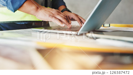 Man, laptop and hands with typing for construction, floor plan inspection and building renovation of development. Engineer, technology and project management with maintenance for infrastructure 126387472