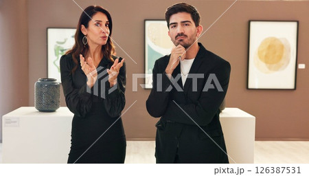 Woman, man and exhibition with discussion in art gallery for negotiation, talk and explain deal. People, portrait and customer with museum, guide and display with culture, talent or pov at event 126387531