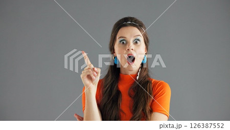 Woman, pointing and shock info in studio for advertising, announcement wow or news about us on gray background. Mockup space, portrait or coming soon with sign or direction for surprise launch Woman, pointing and shock info in studio for advertising, announcement wow or news about us on gray background. Mockup space, portrait or coming soon with sign or direction for surprise launch 126387552