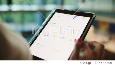Tablet, screen and hand with smart home app for security system, dashboard and change network settings. Display, technology and woman control house, lights or air conditioning automation closeup 126387706