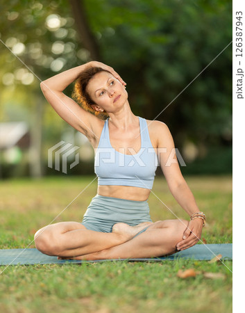 Various yoga poses performed by slender woman in fresh air in summer garden Various yoga poses performed by slender woman in fresh air in summer garden 126387943