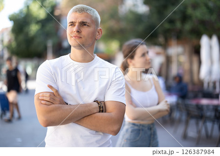 Angry interlocutors ignore each other, turn away in different directions. Husband and wife are in silent confrontation. Angry interlocutors ignore each other, turn away in different directions. Husband and wife are in silent confrontation. 126387984
