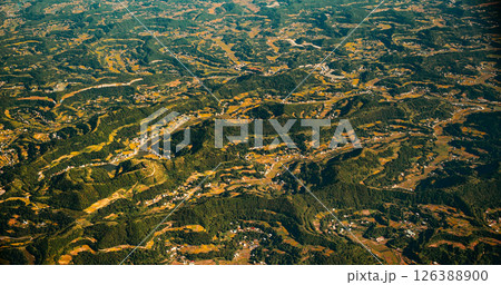 View From Airplane Window On Private Buildings, China. Mountainous Wooded Terrain Landscape Of China. Porthole View Or Called Bull's-eye Window. Discover China View From Airplane Window On Private Buildings, China. Mountainous Wooded Terrain Landscape Of China. Porthole View Or Called Bull's-eye Window. Discover China 126388900