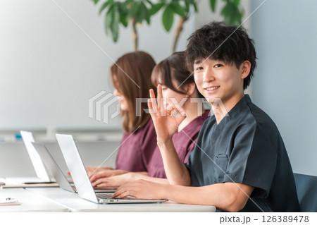医療,カンファレンス・勉強会・セミナー・研修・研修を受けるスクラブ姿の男女医療スタッフ 126389478