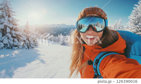 Smiling Woman Hiking in Snowy Mountains Taking a Winter Selfie 126390016
