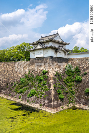 Stone walls and turret of Osaka Castle, Japan, with moat reflection Stone walls and turret of Osaka Castle, Japan, with moat reflection 126390666
