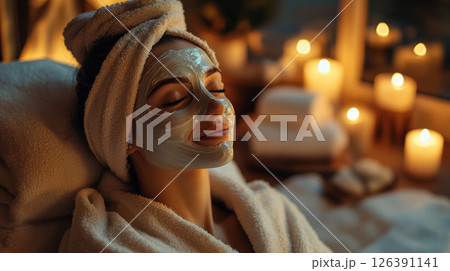 Woman Relaxing with a Spa Facial Mask in Candlelight Ambience 126391141