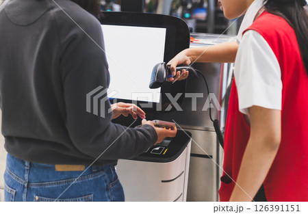 Woman self check in with hand scanning barcode in the airport. 126391151
