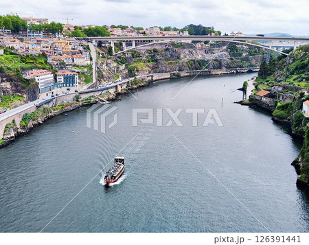 The view from the Douro River to Porto's riverside. Buildings at the shore, ship in the river. Portugal getaway  126391441